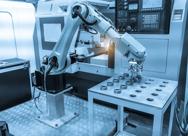 Robotic arms can be programmed for non-machining tasks such as parts handling.
